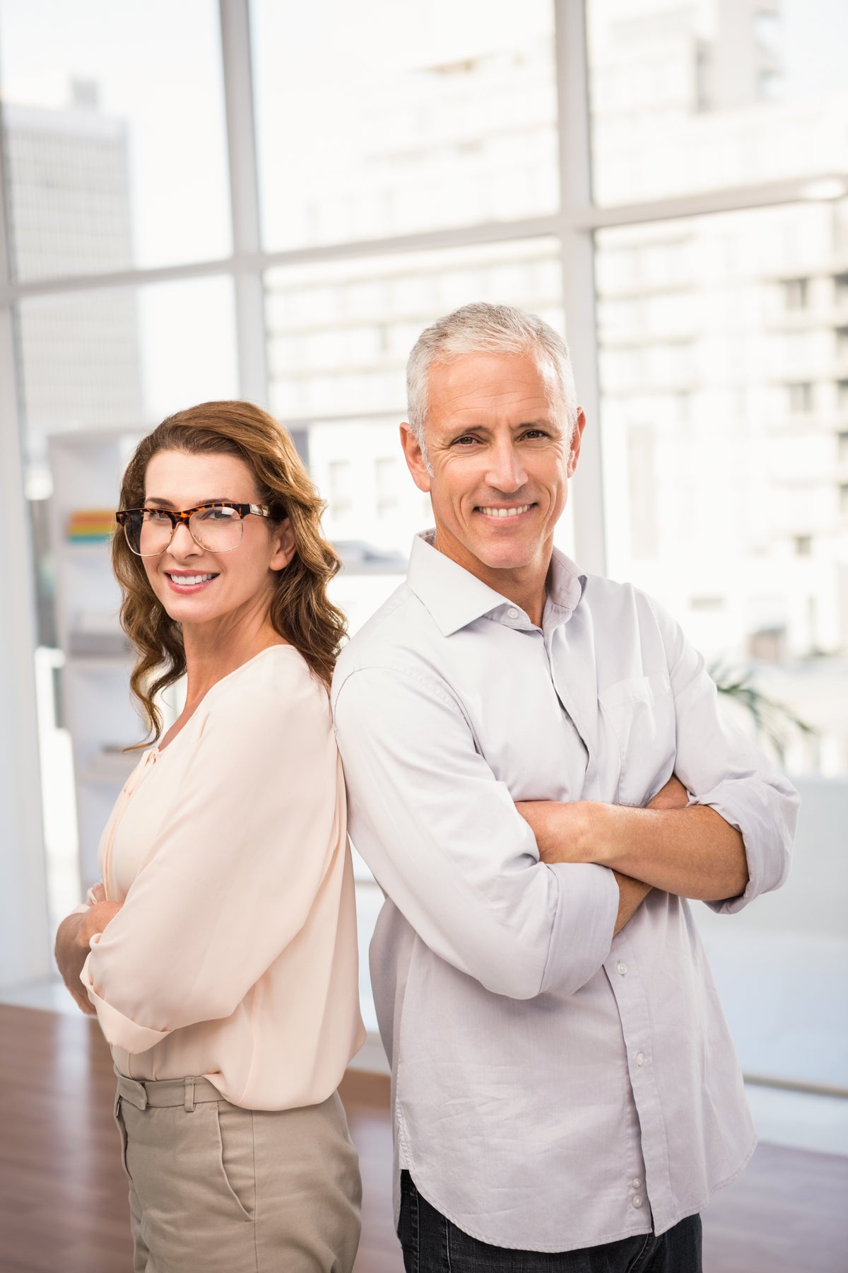 smiling-casual-business-colleagues-with-arms-crossed
